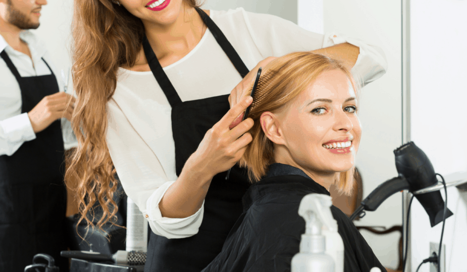 Hairdresser combing clients hair